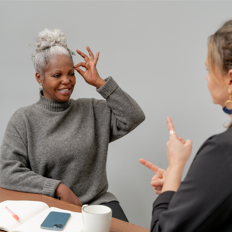 Two people signing to each other